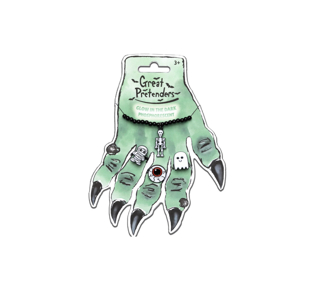 A cute ghost, mummy, and eyeball ring and a chain necklace with a hanging skeleton pendant all packaged on a green witches hand with black fingernails. 