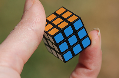 Hnad holding world's smallest Rubiks Cube.