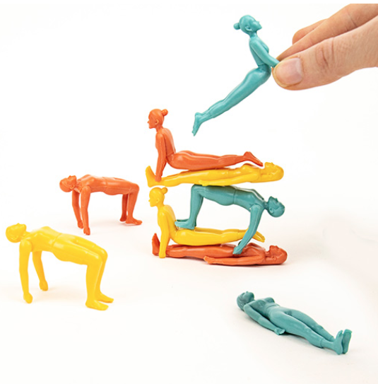 Stacking of plastic figures in various yoga poses.