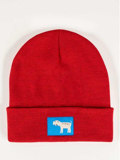 Red beanie with white dog on a blue tag embroidered on the front. 